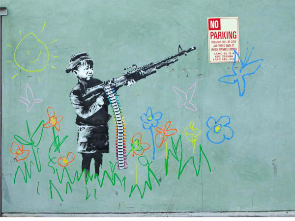 Banksy’s 2011 Crayon Boy mural depicts child drawing soldiers, blending innocence and striking imagery.