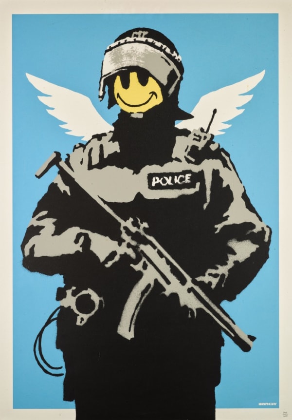Banksy’s 2003 Flying Copper shows armed officer with smiley face, striking satirical street art.