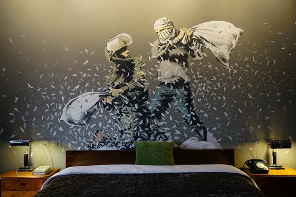 Banksy, The Walled Off Hotel, Bethlehem, 2017 – street art landmark featuring galleries, installations, and “the worst view in the world.”