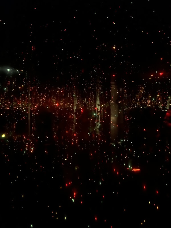 Yayoi Kusama, Infinity Mirror Room installation with glowing LED lights, mirrored walls creating endless reflections in immersive darkened space.