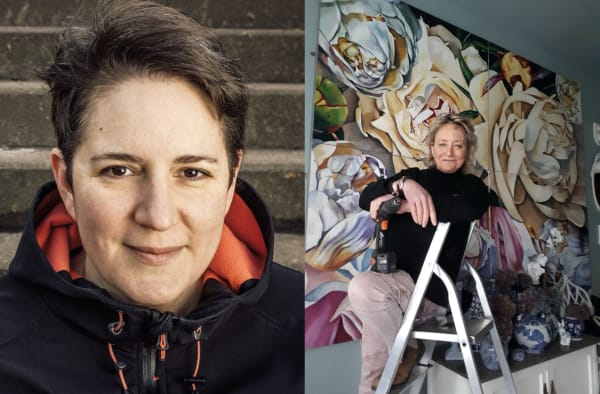 Portrait of two people with one on a ladder next to a floral mural.