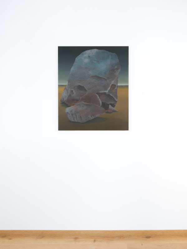 Painting titled “The Circular Ruins” (2023) by Silvia Giordani. The artwork features a monumental rock formation with textured surfaces, set against a soft, atmospheric gradient background. The composition evokes themes of timelessness and transformation. Acrylic and oil on canvas. © Buysse Gallery.