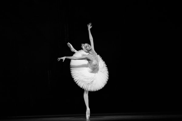 Ballerina Anna Nikulina of The Bolshoi Ballet dancing in Swan Lake. At The Royal Opera House, London, UK. Dancer. By movement photographer Simon Tomkinson.
