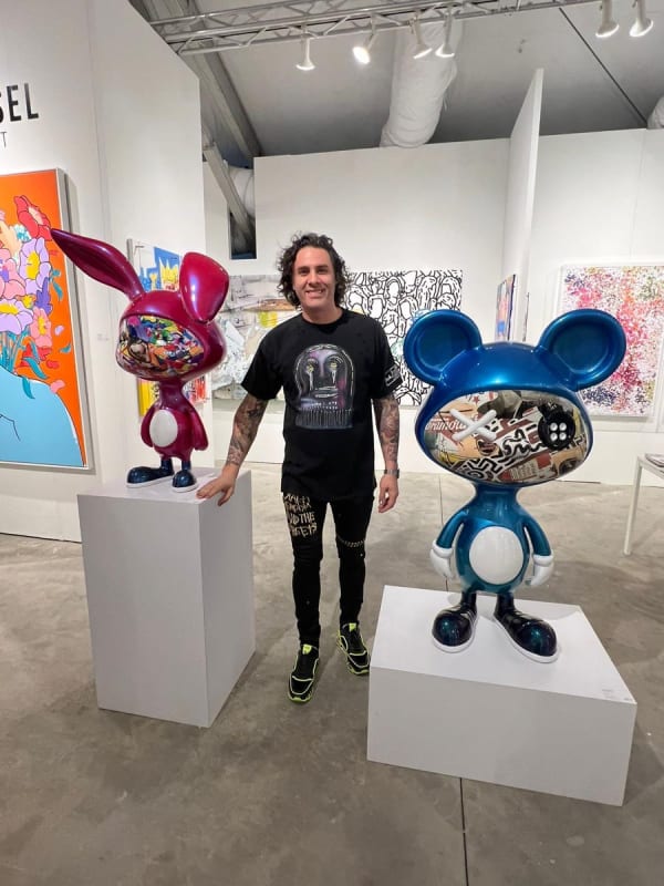 Man in front of sculptures at Carousel Fine Art's booth at the art fair, Context Art Miami 2022.