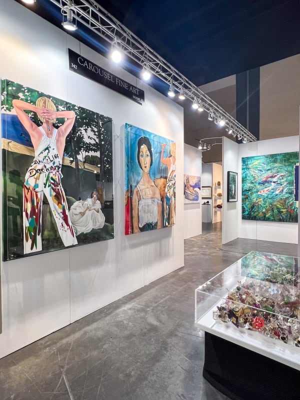 Paintings displayed at Carousel Fine Art's booth at the Palm Beach Show art fair, 2023.