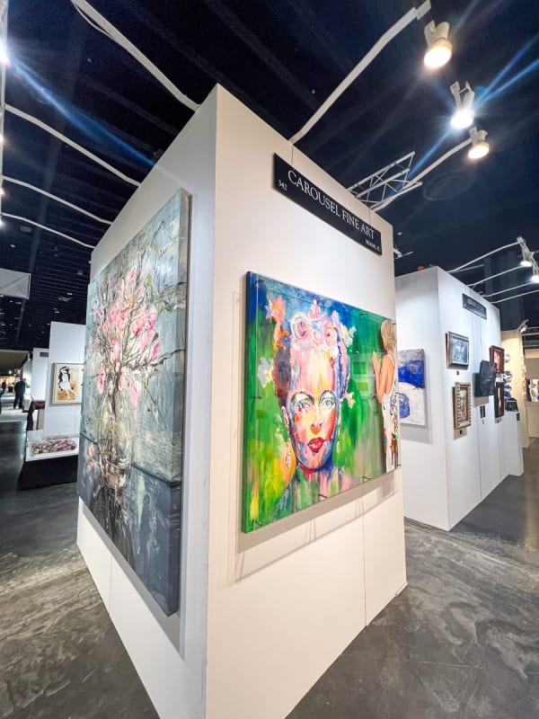 Paintings displayed at Carousel Fine Art's booth at the Palm Beach Show art fair, 2023.
