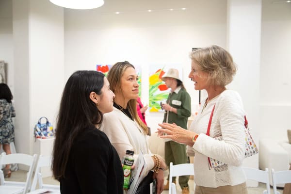 People at Carousel Fine Art's gallery space in Buckhead Village, Atlanta during the Caroline Dechamby Retrospective.