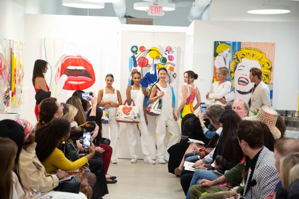 Models posing at runway in gallery space in Buckhead Village, Atlanta during the Caroline Dechamby Retrospective.