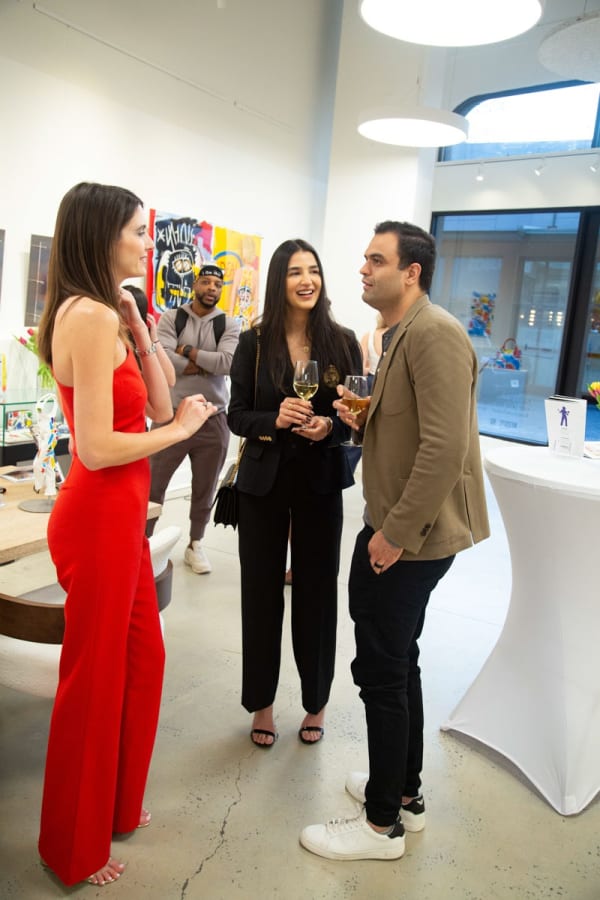 People at Carousel Fine Art's gallery space in Buckhead Village, Atlanta during the Caroline Dechamby Retrospective.