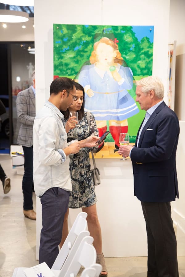 People in front of Carousel Fine Art's gallery space in Buckhead Village, Atlanta during the Caroline Dechamby Retrospective.