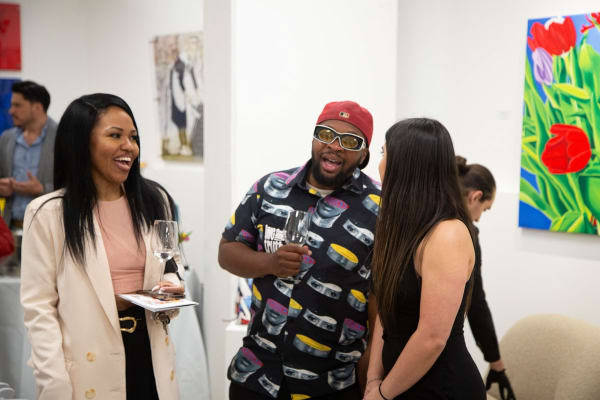 People at Carousel Fine Art's gallery space in Buckhead Village, Atlanta during the Caroline Dechamby Retrospective.