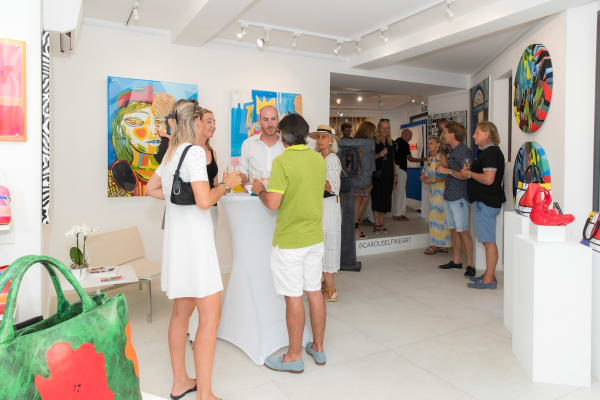 People inside of Carousel Fine Art's gallery space in Saint Tropez.
