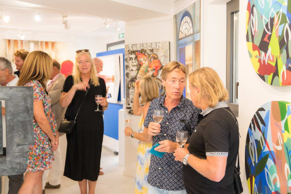 People inside of Carousel Fine Art's gallery space in Saint Tropez.