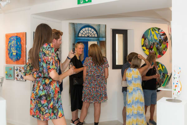People inside of Carousel Fine Art's gallery space in Saint Tropez.