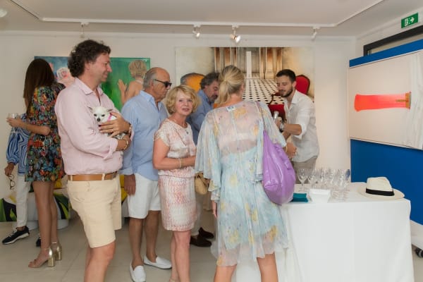 People inside of Carousel Fine Art's gallery space in Saint Tropez.