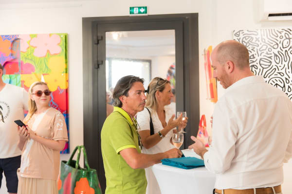 People inside of Carousel Fine Art's gallery space in Saint Tropez.