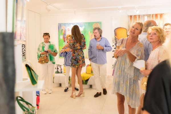 People inside of Carousel Fine Art's gallery space in Saint Tropez.