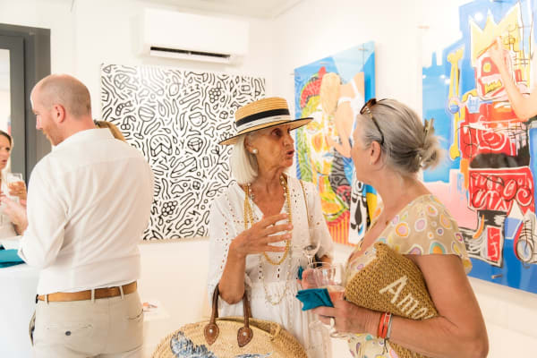 People inside of Carousel Fine Art's gallery space in Saint Tropez.