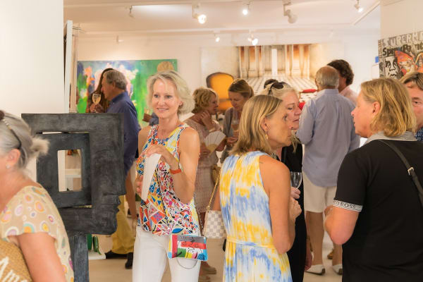 People inside of Carousel Fine Art's gallery space in Saint Tropez.
