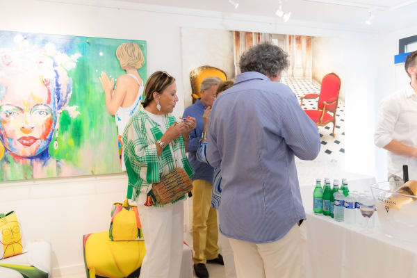 People inside of Carousel Fine Art's gallery space in Saint Tropez.
