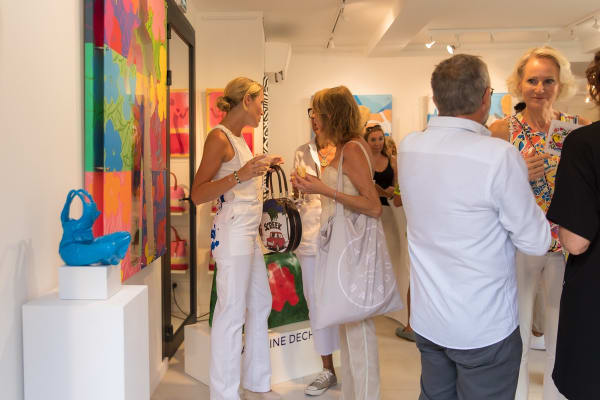 People inside of Carousel Fine Art's gallery space in Saint Tropez.
