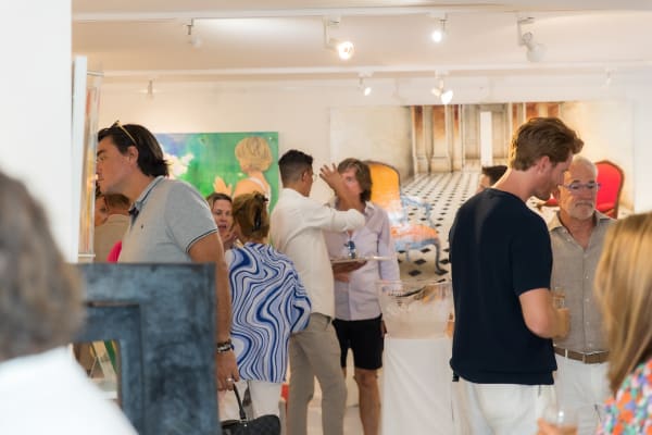 People inside of Carousel Fine Art's gallery space in Saint Tropez.
