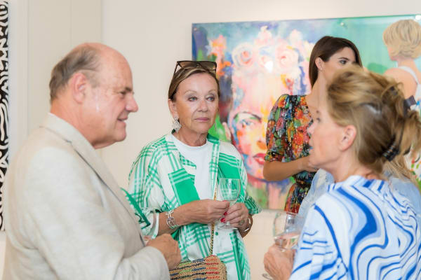 People inside of Carousel Fine Art's gallery space in Saint Tropez.