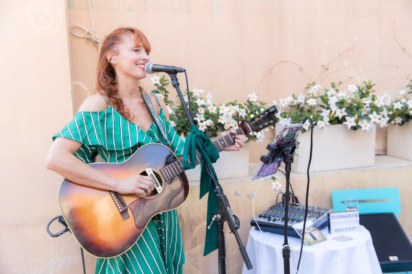 Woman playing music inside of Carousel Fine Art's gallery space in Saint Tropez.