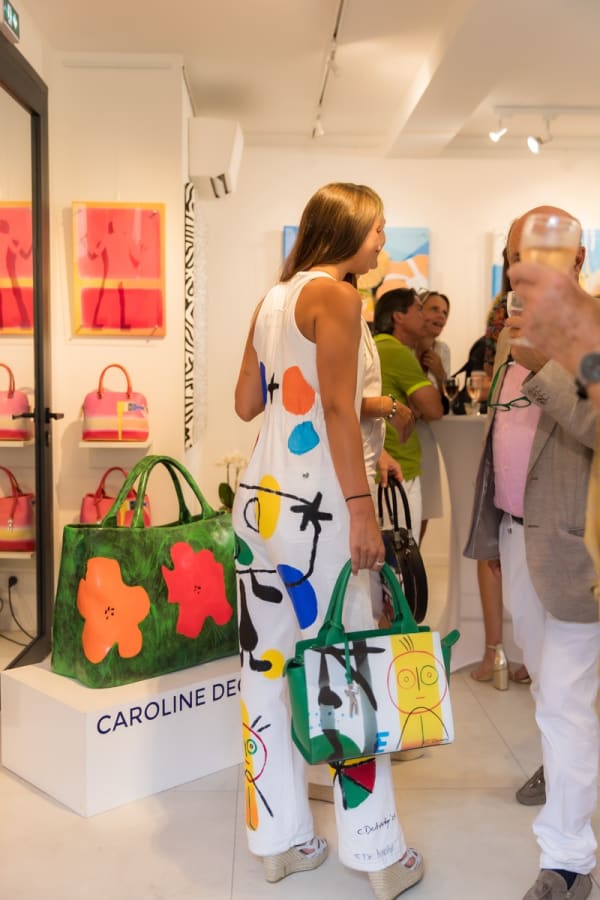 People inside of Carousel Fine Art's gallery space in Saint Tropez.