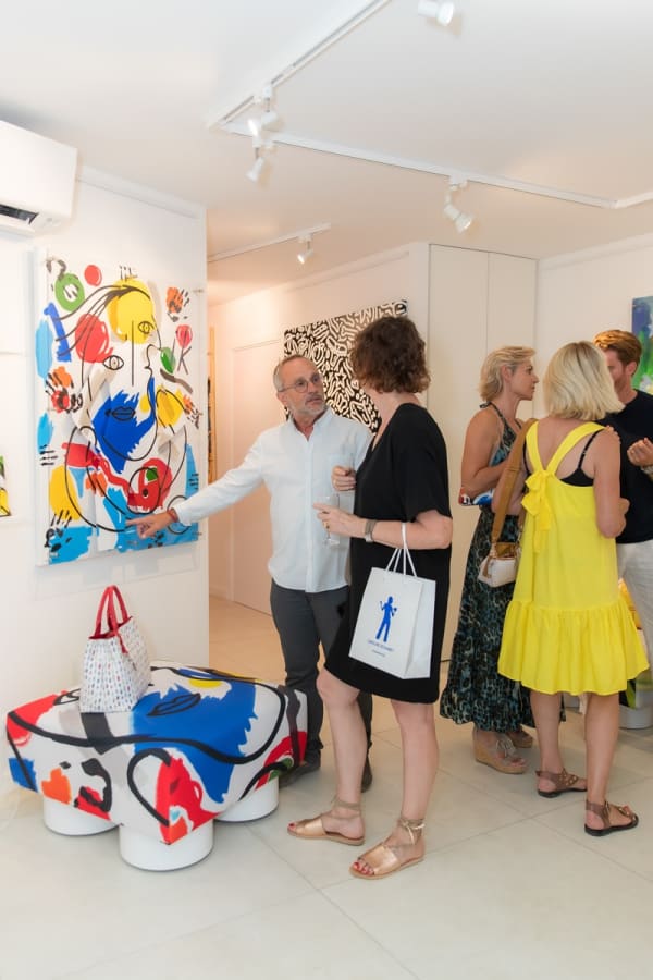 People inside of Carousel Fine Art's gallery space in Saint Tropez.