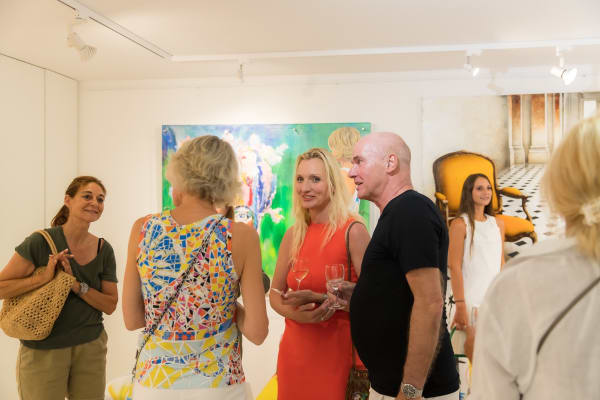 People inside of Carousel Fine Art's gallery space in Saint Tropez.