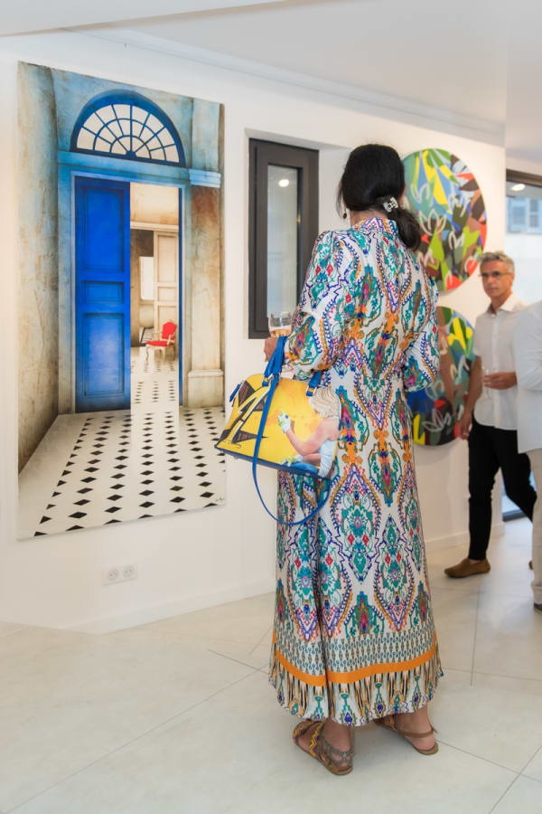 People looking at a painting in Carousel Fine Art's gallery space in Saint Tropez.
