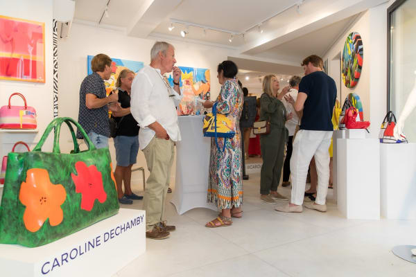 People inside of Carousel Fine Art's gallery space in Saint Tropez.