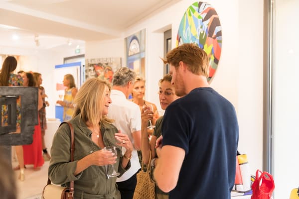 People inside of Carousel Fine Art's gallery space in Saint Tropez.