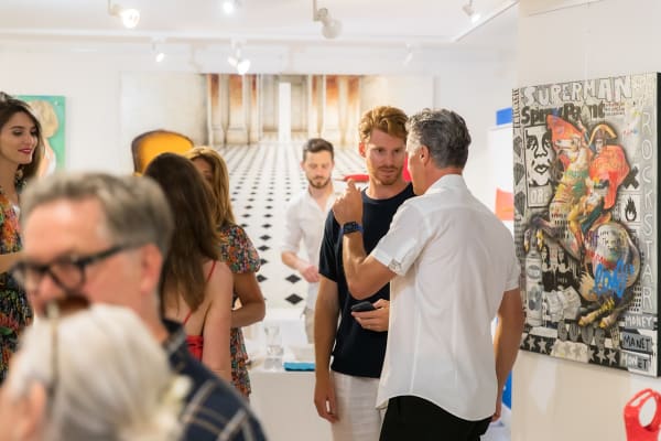 People inside of Carousel Fine Art's gallery space in Saint Tropez.