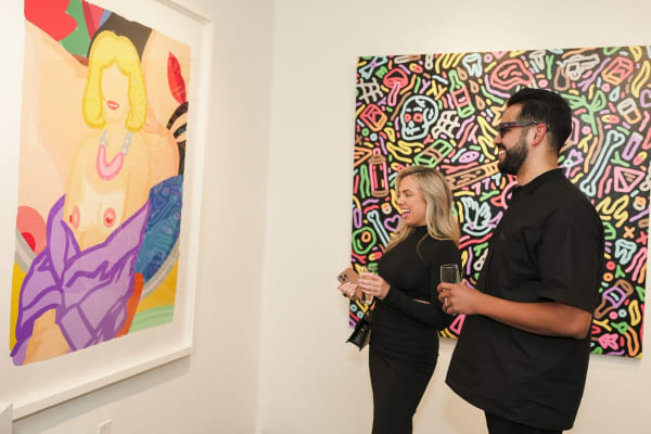 People staring at painting displayed in Carousel Fine Art's Miami gallery space during the Grand Opening.