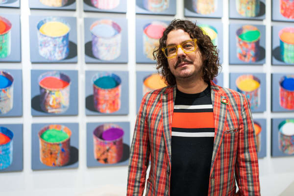 Man in front of painting displayed in Carousel Fine Art's Miami gallery space during the Grand Opening.