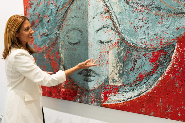 Woman pointing at painting in Carousel Fine Art's Miami gallery space during the Grand Opening.