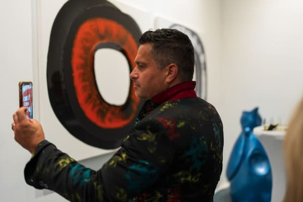 Man next to painting displayed in Carousel Fine Art's Miami gallery space during the Grand Opening.
