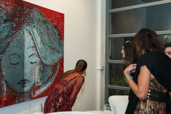 People staring at painting in Carousel Fine Art's Miami gallery space during the Grand Opening.