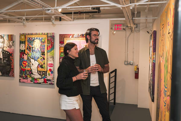 People staring at painting displayed in Carousel Fine Art's Miami gallery space during the Grand Opening.