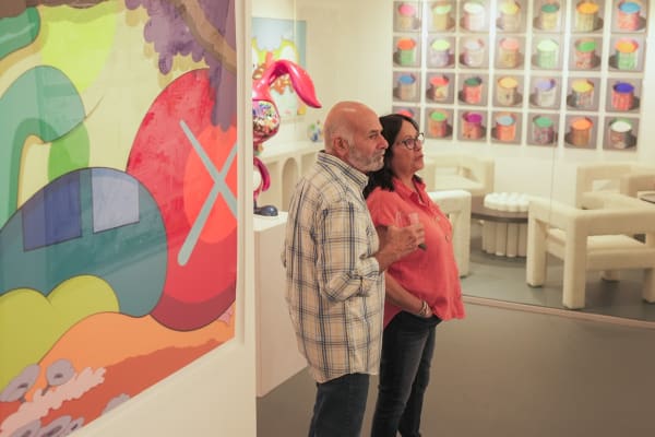 People staring at painting displayed in Carousel Fine Art's Miami gallery space during the Grand Opening.
