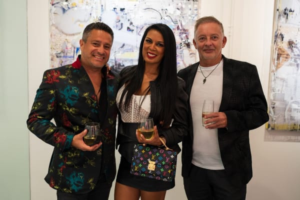 People posing in Carousel Fine Art's Miami gallery space during the Grand Opening.