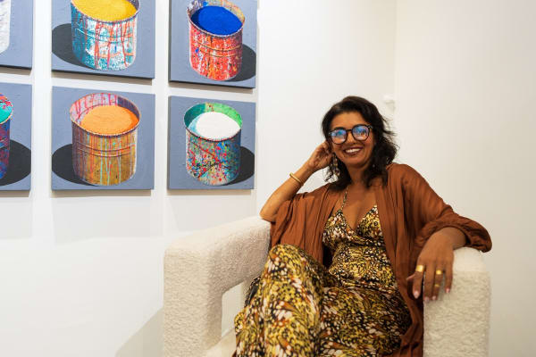 Woman sitting on chair in Carousel Fine Art's Miami gallery space during the Grand Opening.