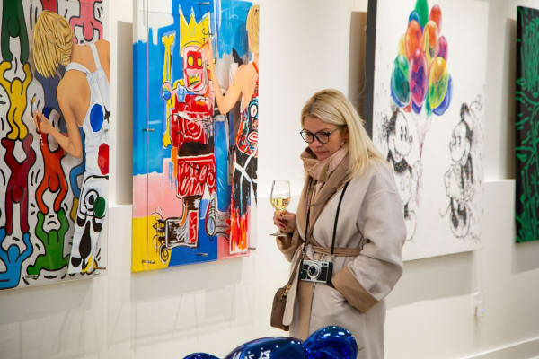Woman in Carousel Fine Art's new gallery space in Buckhead Village, Atlanta during an event for their grand opening.
