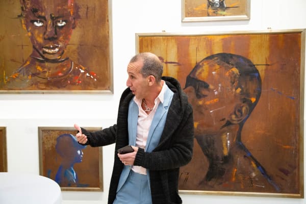 Man at Carousel Fine Art's new gallery space in Buckhead Village, Atlanta during an event for their grand opening.