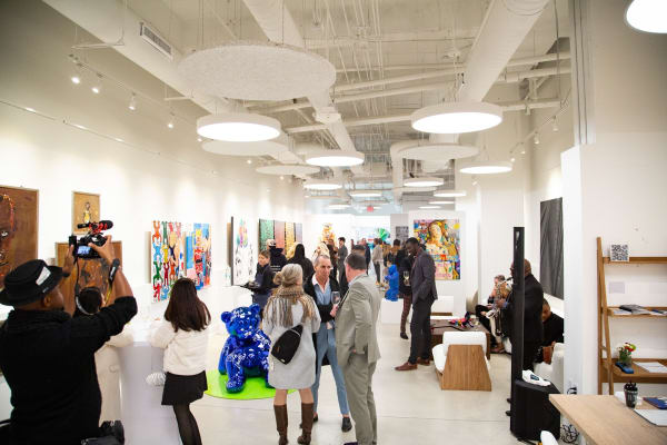 People at Carousel Fine Art's new gallery space in Buckhead Village, Atlanta during an event for their grand opening.
