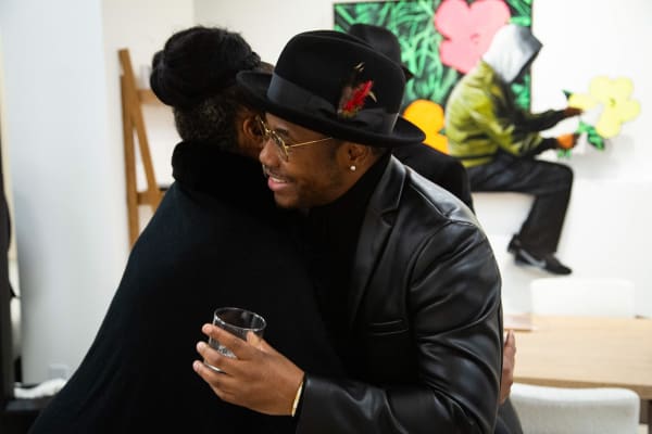 People hugging at Carousel Fine Art's new gallery space in Buckhead Village, Atlanta during an event for their grand opening.