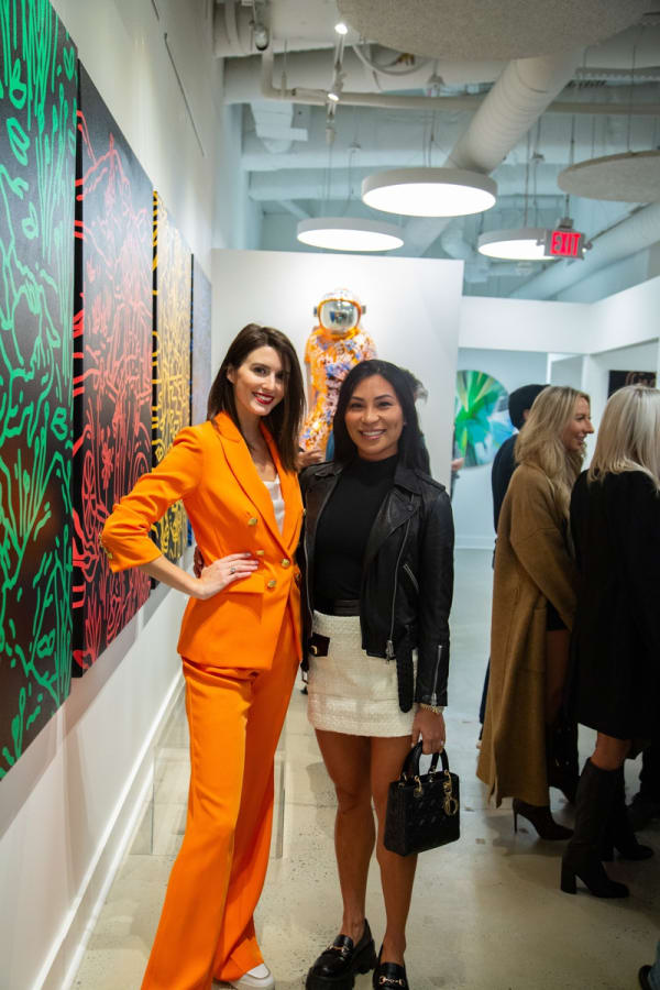 Women posing at Carousel Fine Art's new gallery space in Buckhead Village, Atlanta during an event for their grand opening.