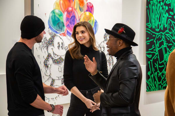 People talking at Carousel Fine Art's new gallery space in Buckhead Village, Atlanta during an event for their grand opening.